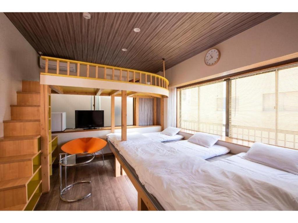 a bedroom with two beds and a bunk bed at BEYOND HOTEL Takayama 2nd - Vacation STAY 82237 in Takayama