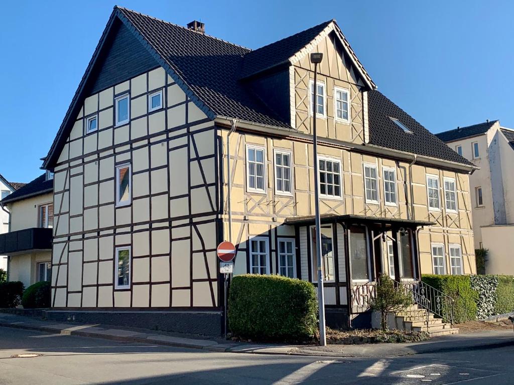 a brown and white building with a black roof at Gästehaus am Kurpark in Horn-Bad Meinberg