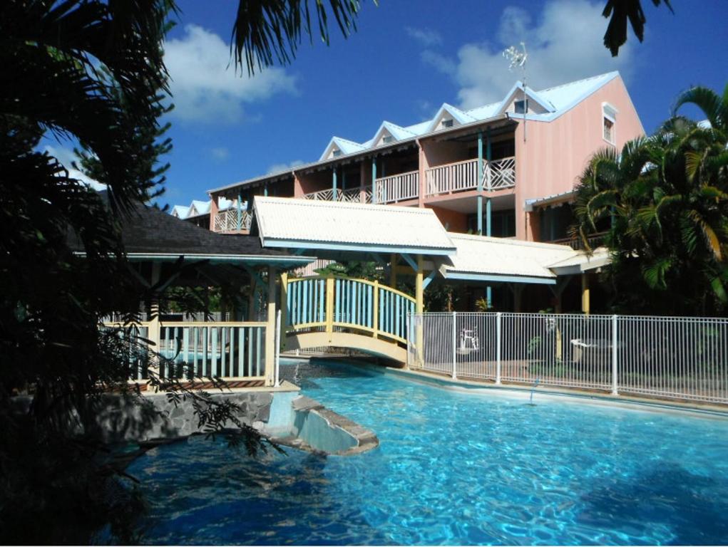 a resort with a pool in front of a building at Studio paisible à Sainte-Anne avec piscine partagée - 18 m² in Sainte-Anne