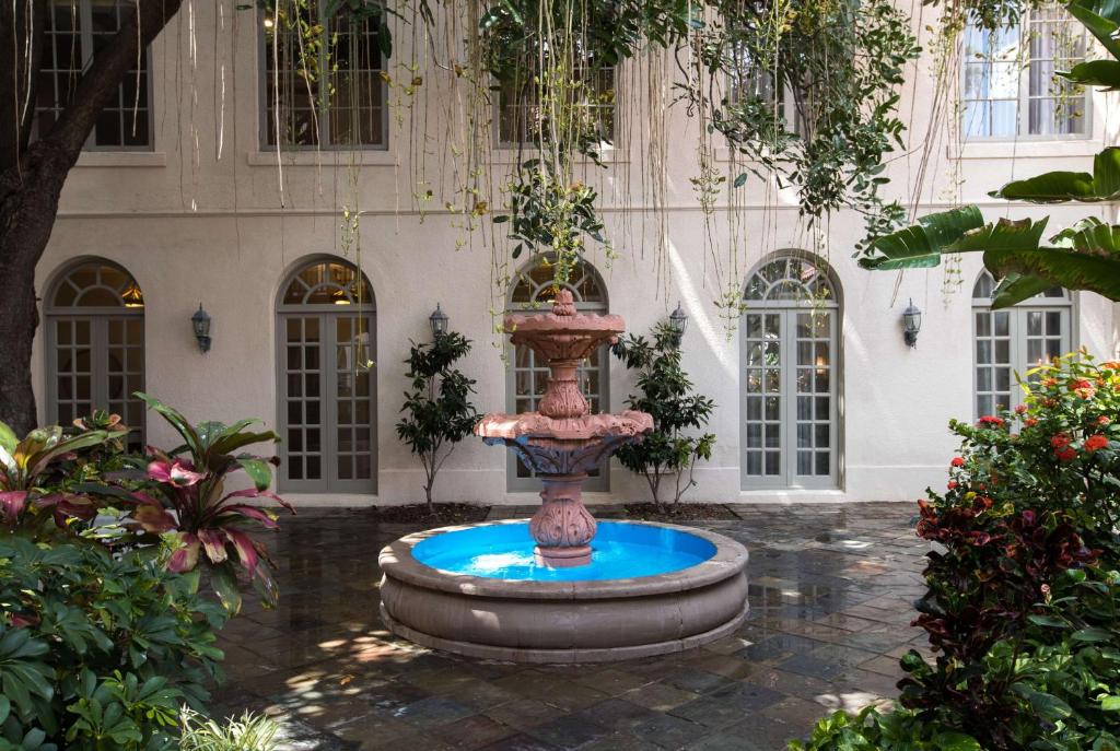 a fountain in the courtyard of a building at Casa De Palmas, Trademark Collection by Wyndham in McAllen