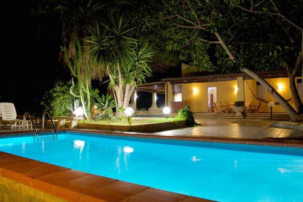 een zwembad voor een huis 's nachts bij 3 bedrooms villa at Sciacca 400 m away from the beach with sea view private pool and enclosed garden in Case San Marco