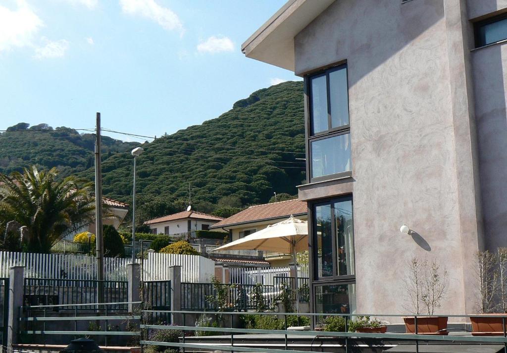 a building with a mountain in the background at Etna Holiday Home in Nicolosi