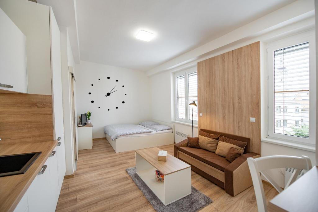 a living room with a couch and a bed at Soho apartment in Písek