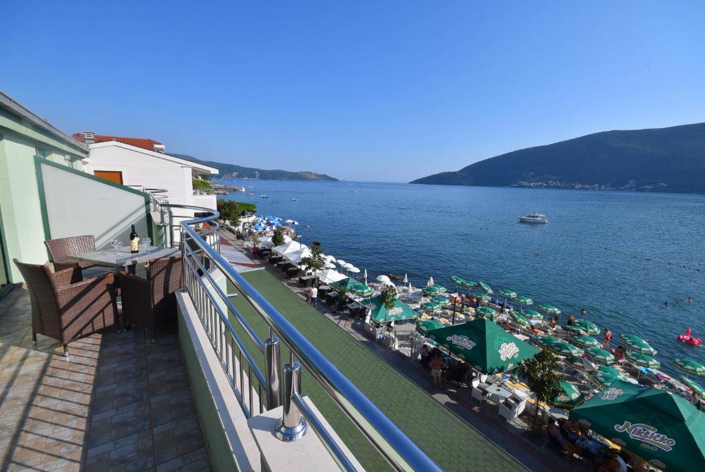 a balcony with a view of a body of water at Apartmani Amor in Herceg-Novi