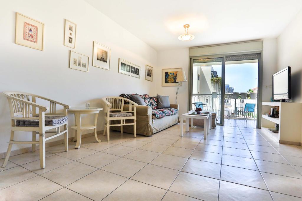 a living room with a couch and a table at Jaffa Experience Home in Tel Aviv