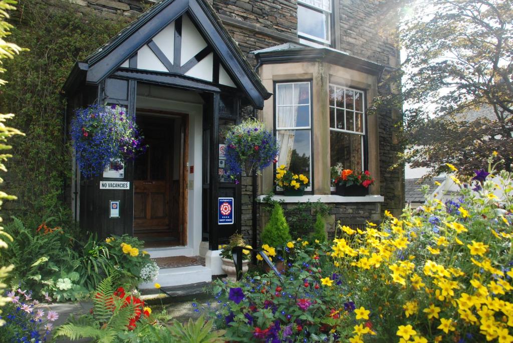 a house with flowers in front of it at Denehurst Guest House in Windermere