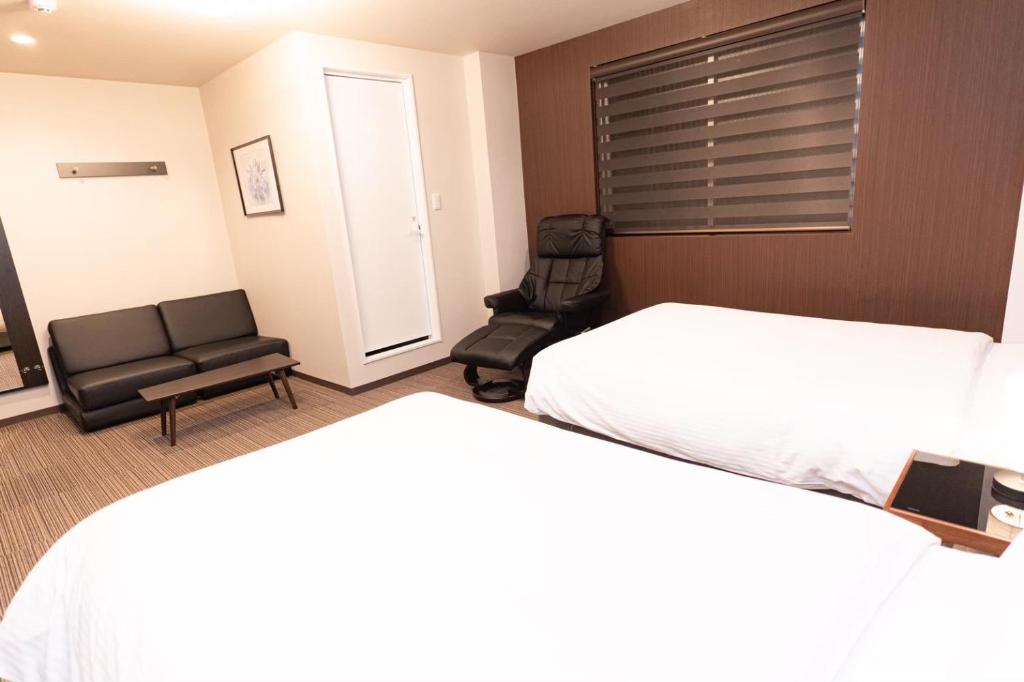 Postel nebo postele na pokoji v ubytování Hotel Kojan