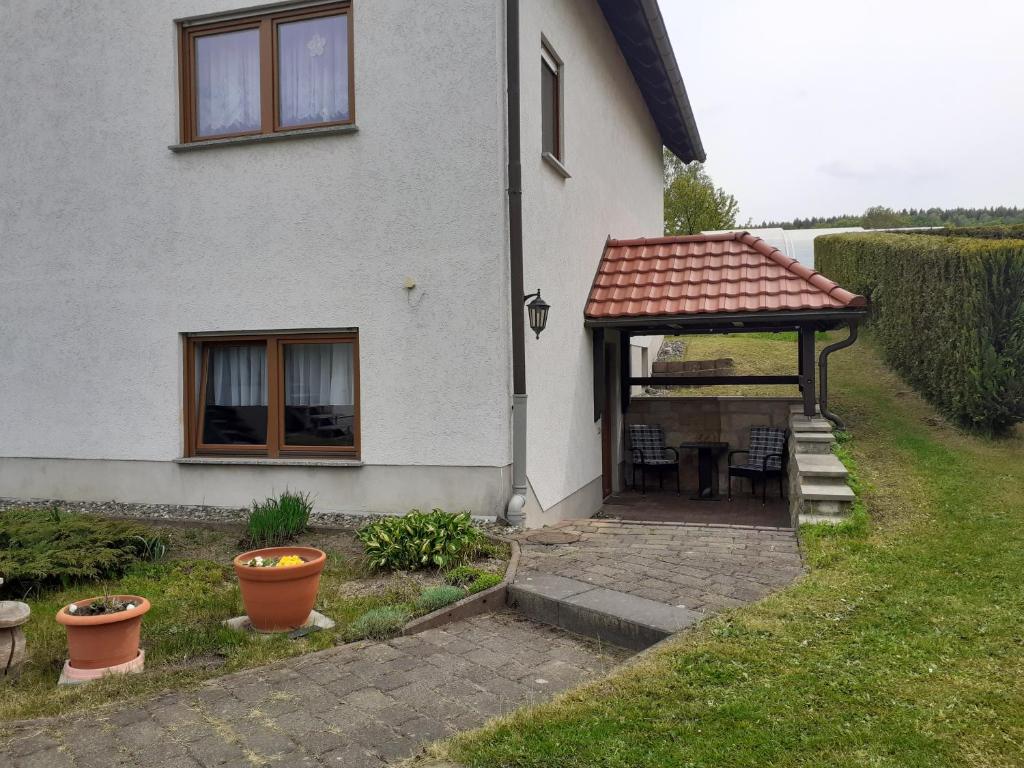 a house with a gazebo and a patio at Ferienwohnung Fischer in Kurort Gohrisch