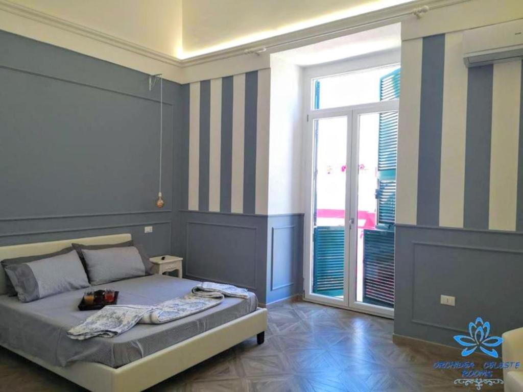 een slaapkamer met een bed en een groot raam bij B&B Orchidea Celeste in Manfredonia