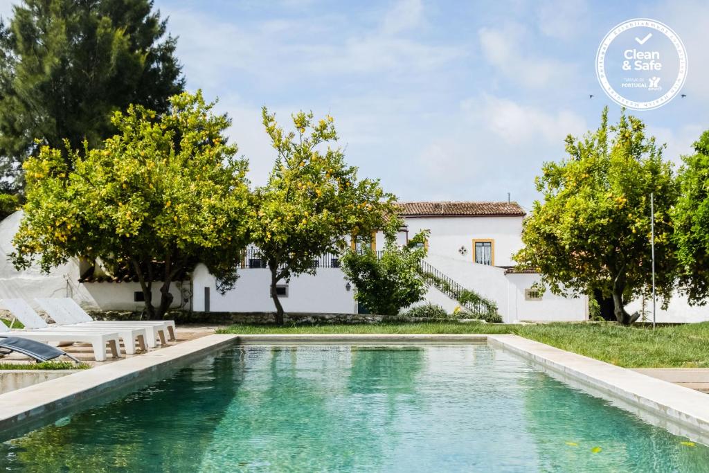 a swimming pool in front of a house with trees at Eighteen21 Houses - Casa dos Condes in Cano