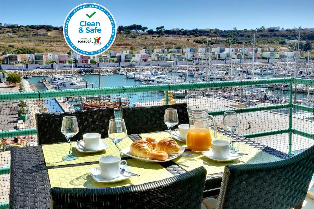 a table with glasses of orange juice and croissants on it at Marina Sea Residence in Albufeira