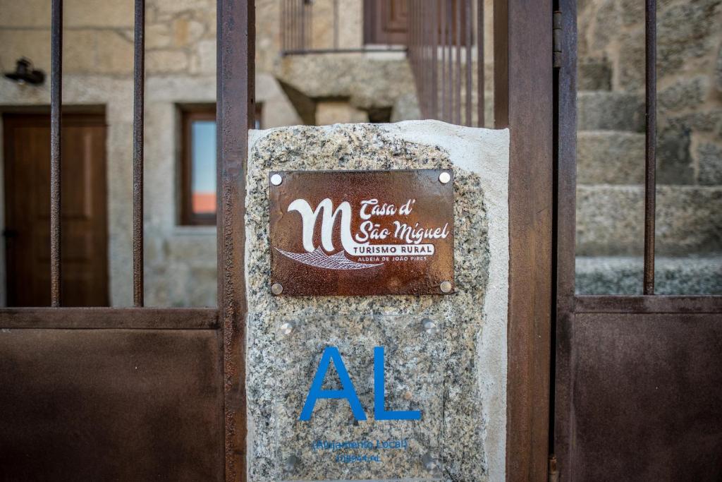 a door with a sign in front of a building at Casa de São Miguel in Aldeia de João Pires