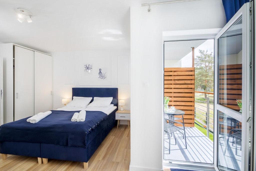 Posteľ alebo postele v izbe v ubytovaní Apartament 12B Niebieskie Apartamenty Poddąbie dawniej Blue Marine z basenem krytym, odkrytym, salą zabaw, animacjami