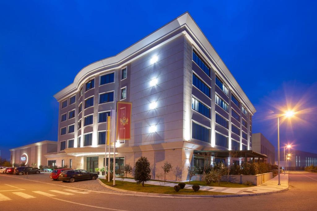 a large building on a street at night at voco - Podgorica, an IHG Hotel in Podgorica