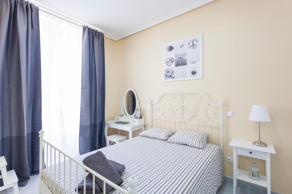 A bed or beds in a room at Boutique Apartments in the Heart of Madrid