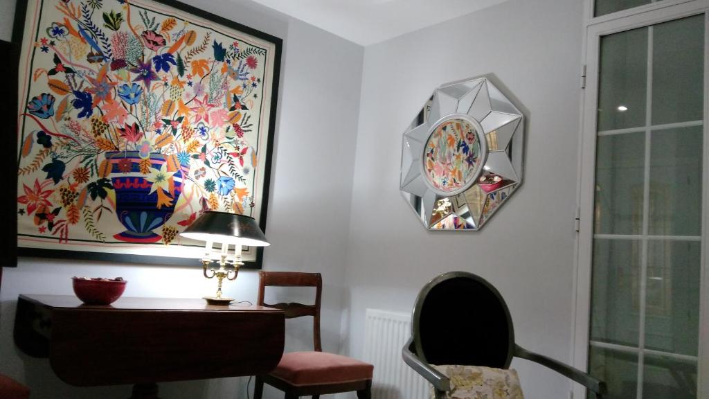 Habitación con escritorio y reloj en la pared en Apartamento Madrid Retiro M-30 en Madrid