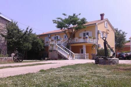 a house with a giraffe statue in front of it at Apartments Nella in Sveti Anton