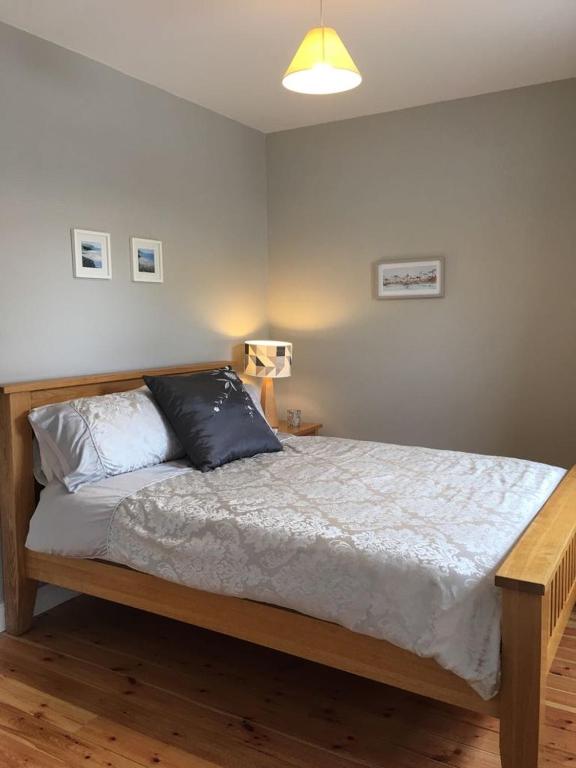 a bedroom with a bed with two pillows on it at Village Way Apartments in Kincasslagh