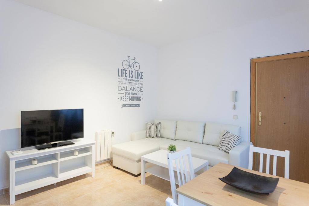 A television and/or entertainment centre at Boutique Apartments in the Heart of Madrid