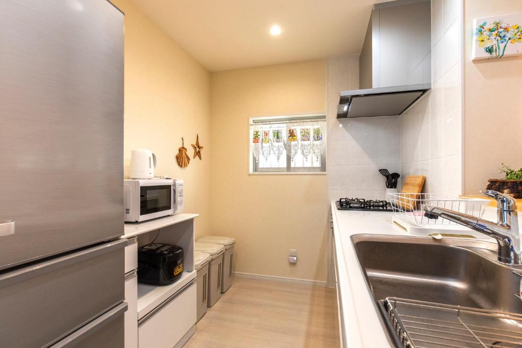 Kuchyň nebo kuchyňský kout v ubytování Condominium Luana 築浅2LDK 宮城海岸徒歩2分 American Village 車で10分