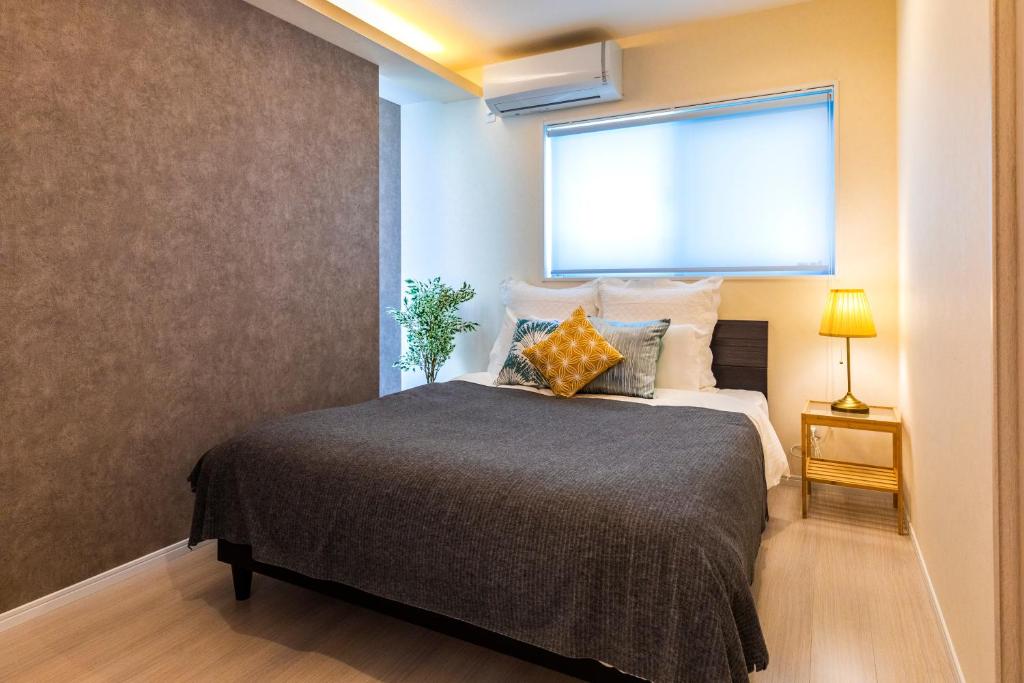 Postel nebo postele na pokoji v ubytování Condominium Luana 築浅2LDK 宮城海岸徒歩2分 American Village 車で10分