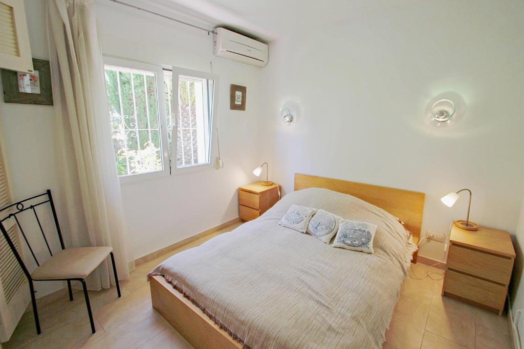 A bed or beds in a room at Michelle - sea view villa with private pool in Benissa