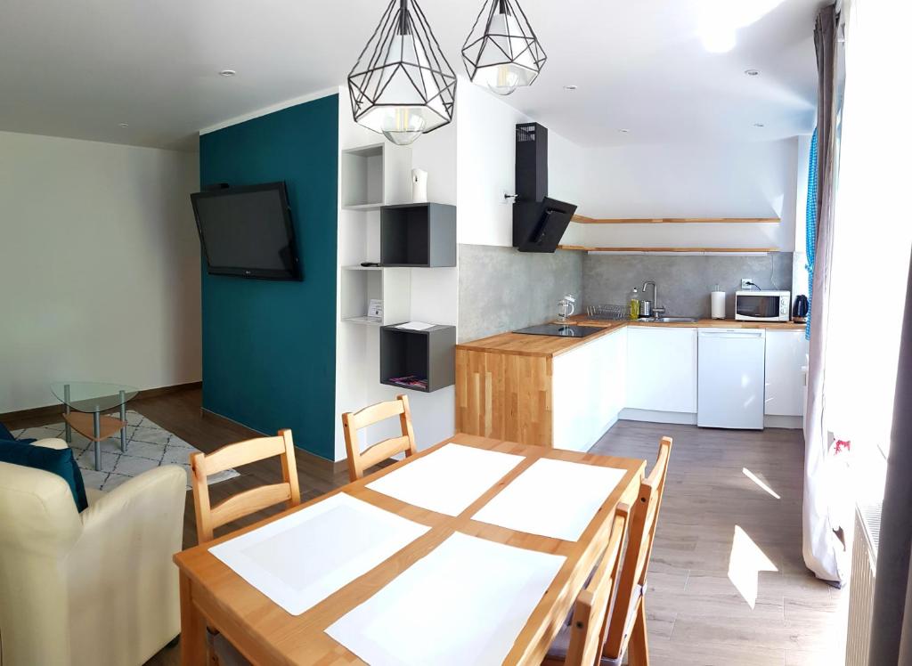 a kitchen and dining room with a table and chairs at Apartament U Janicka in Zakopane