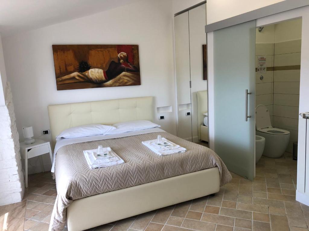 a bedroom with a bed with two plates on it at Attico Luxury B&B in Santa Maria Capua Vetere