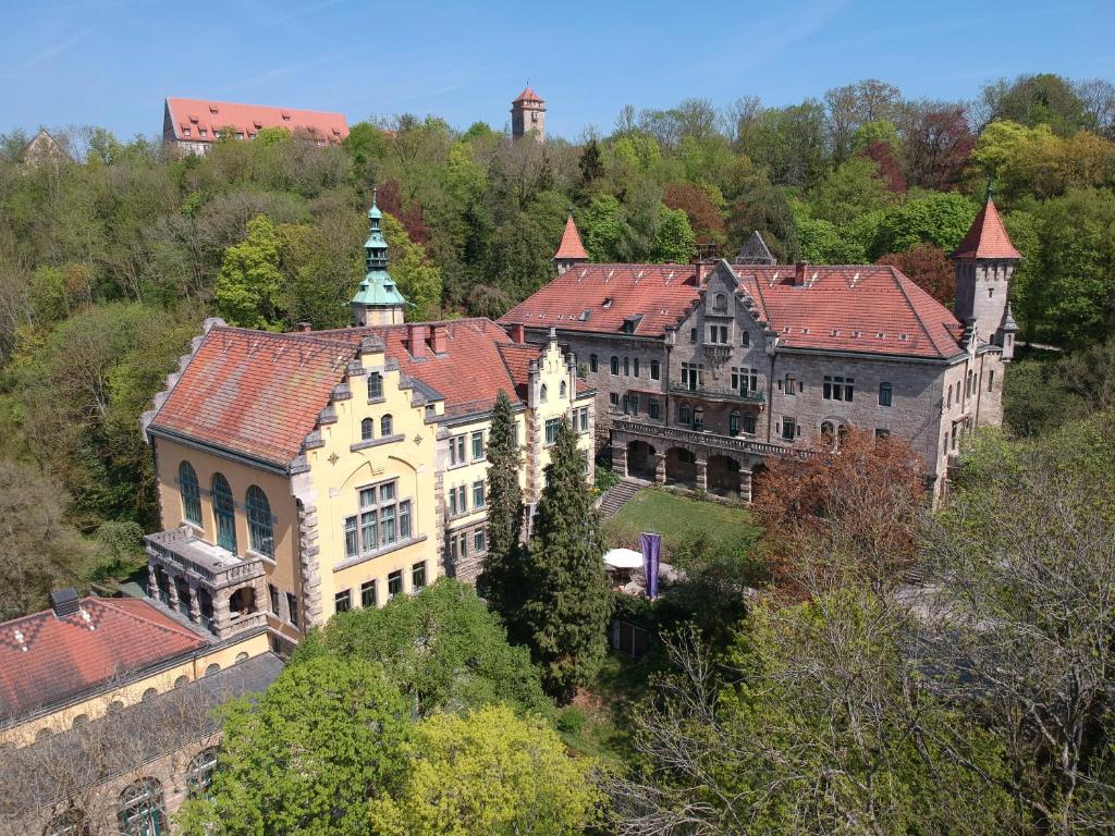 a large building on top of a hill with trees at Wildbad Tagungsort Rothenburg O.D.Tbr. in Rothenburg ob der Tauber