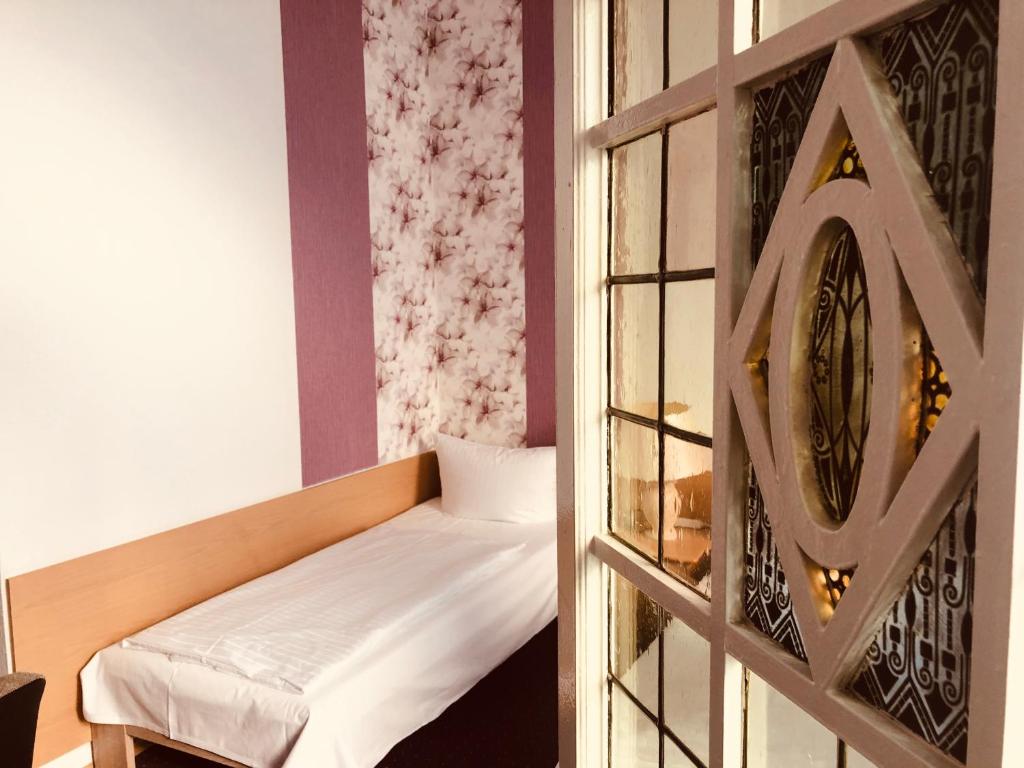 Postel nebo postele na pokoji v ubytování Hotel Castell am Kurfürstendamm