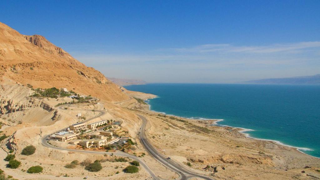 an aerial view of a village on a mountain next to the ocean at HI - Ein Gedi Hostel in Ein Gedi