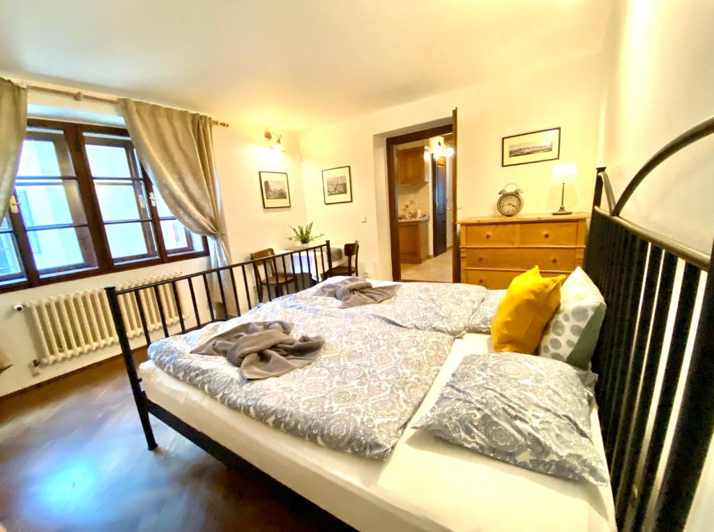 a bedroom with a bed and a dresser at Apartmány Nerudova 36 in Prague
