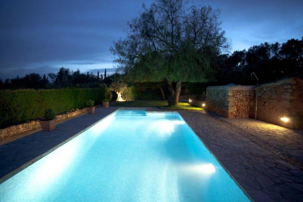 a swimming pool in a yard at night at The Old Cottage - Cas Julians Sencelles Ruberts in Sencelles