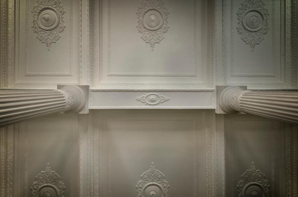 a room with a ceiling with curtains on it at Aristide Hotel - Small Luxury Hotels of the World in Ermoupoli