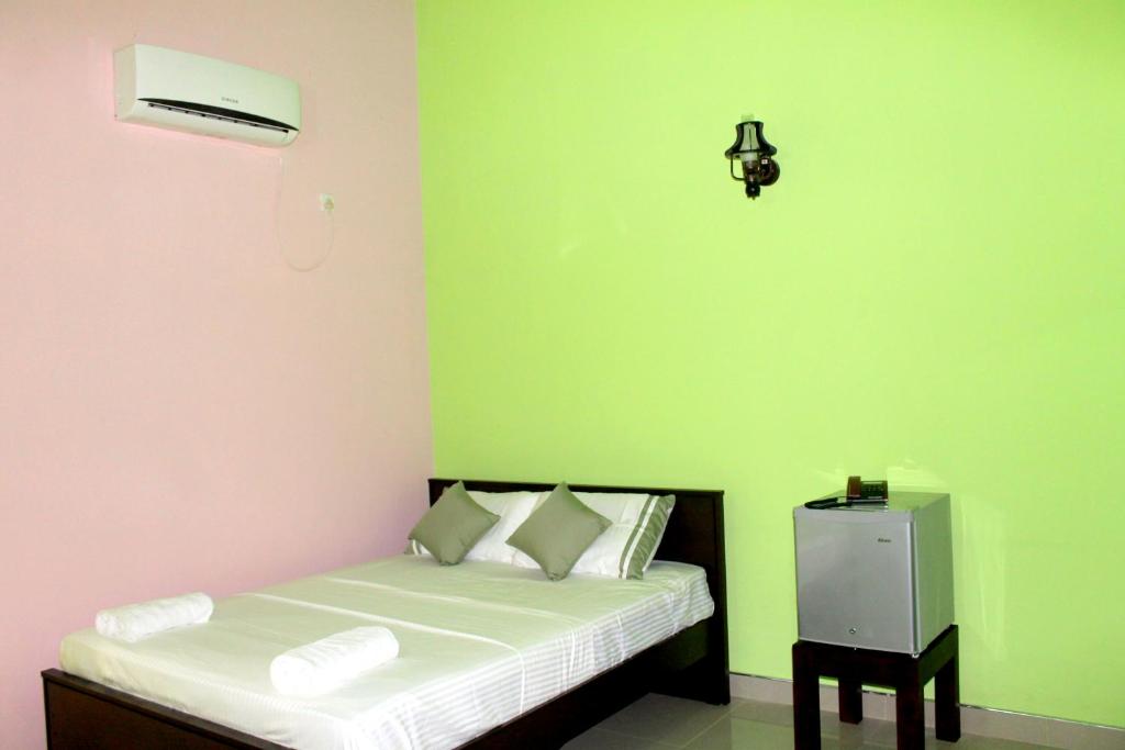 Postel nebo postele na pokoji v ubytování Upul Residence