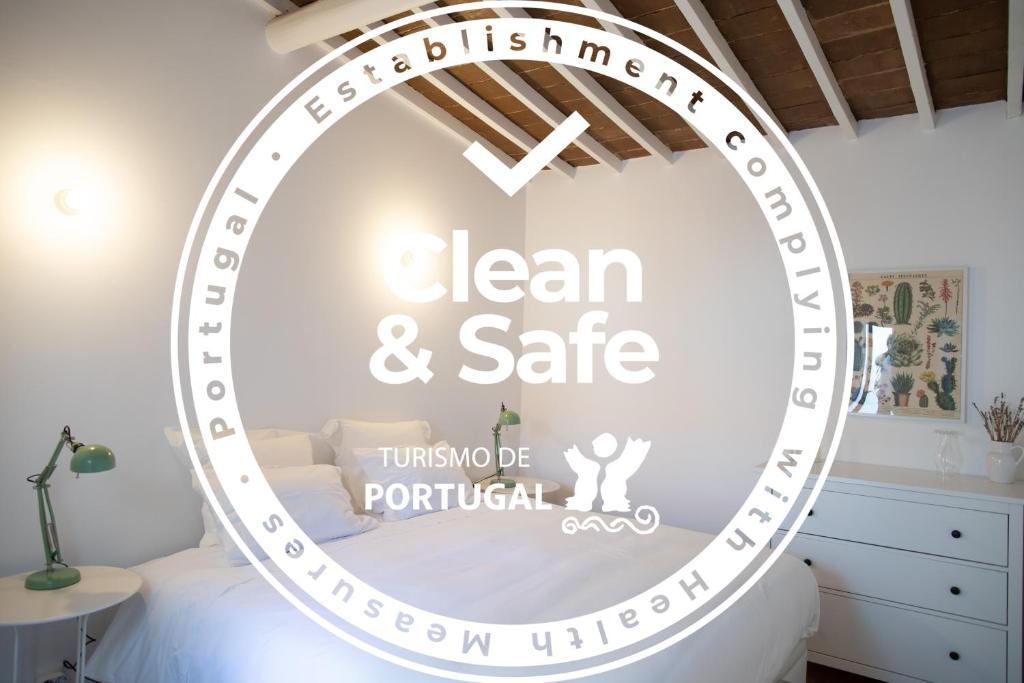 a room with a round mirror with the words clean and safe at Casa da Travessa in Évora