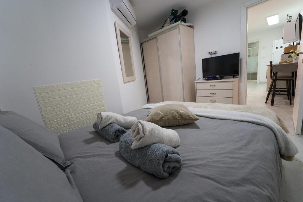 a room with a bed with towels on it at Neviot in Eilat