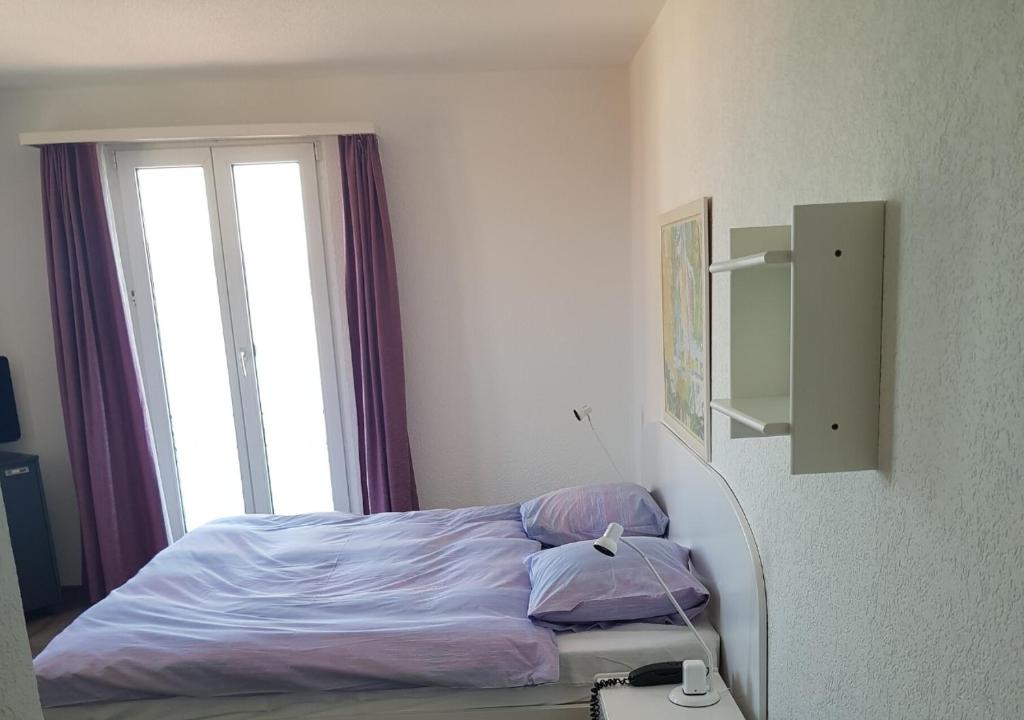 Postel nebo postele na pokoji v ubytování Hotel Le Rivage