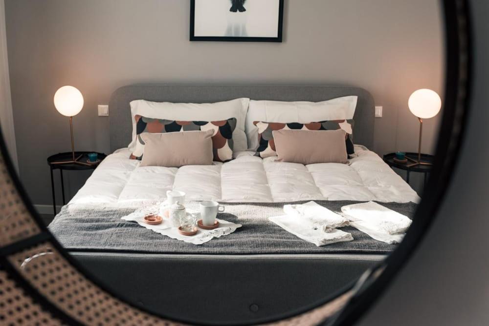 Hotel A-M apartment Borgo Trento, a bedroom with a large white bed with a mirror at A-M apartment Borgo Trento in Verona