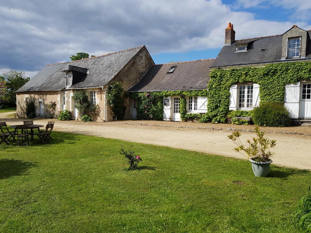 an old house with a yard with a table at Les Roberderies in Broc