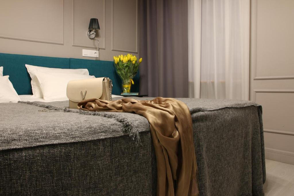 
a bedroom with a bed and a dresser at ReMarka Hotels on Stolyarniy in Saint Petersburg
