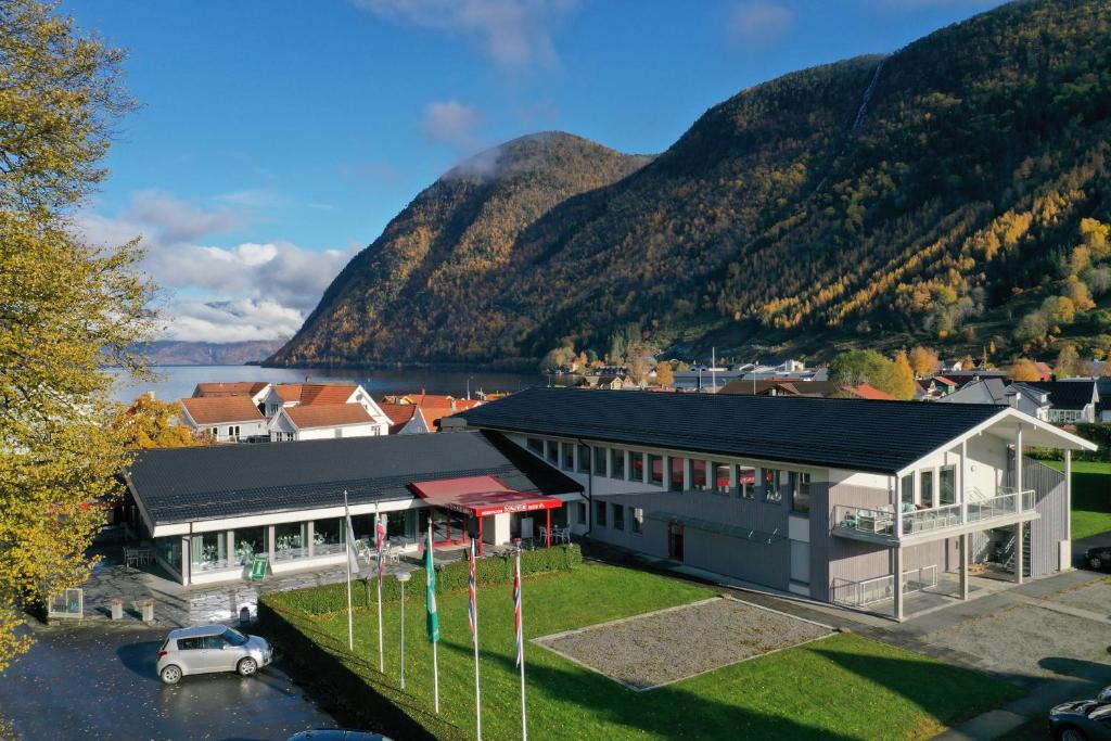an aerial view of a building with a mountain in the background at Blix Hotel in Vikøyri