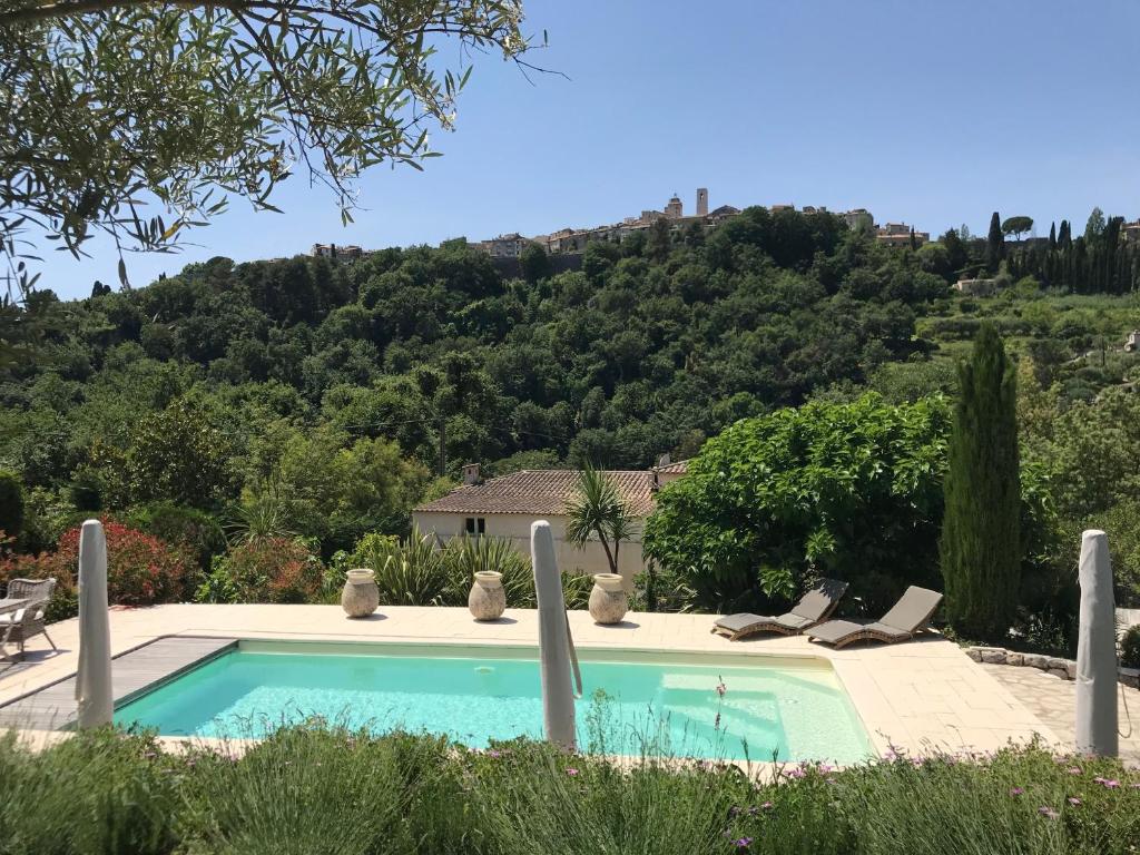 a swimming pool with a mountain in the background at Bastide Nomade - Charming B&B in Saint Paul de Vence