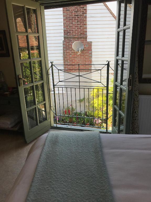 a room with a door open to a balcony at The Tea House in Rye