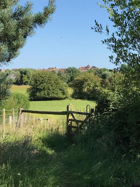 a wooden gate in the middle of a field at The Tea House in Rye