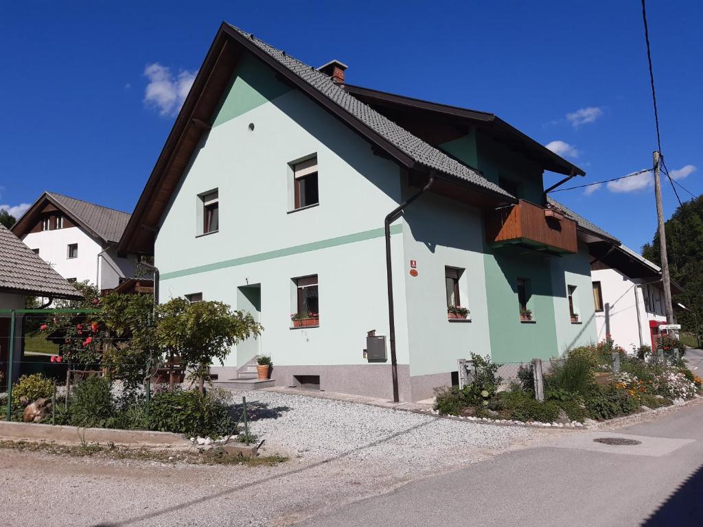 a white and green house with a black roof at SOBE U SIRRC in Bled