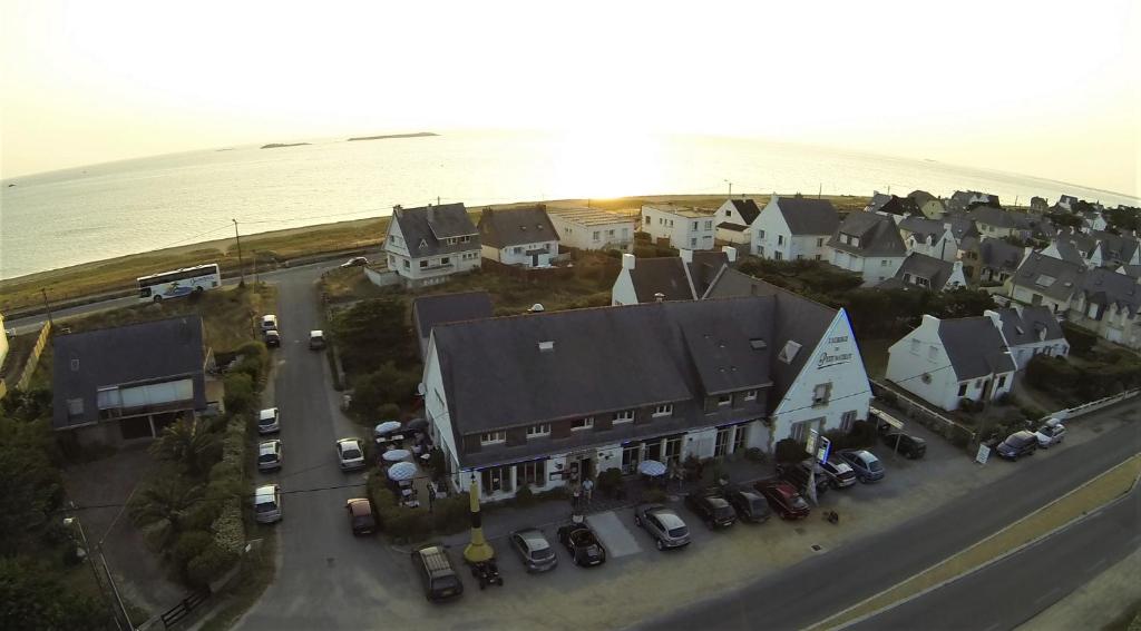 an aerial view of a town with cars parked in a parking lot at Hôtel du Petit Matelot in Saint-Pierre-Quiberon