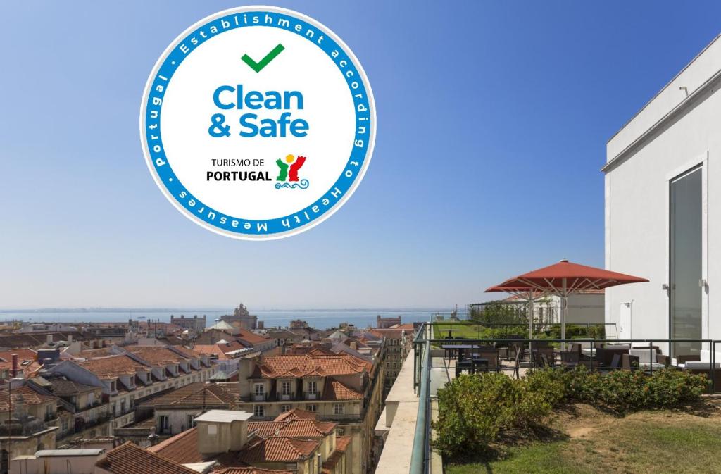 a sign that reads clean and safe with a view of a city at Hotel do Chiado in Lisbon
