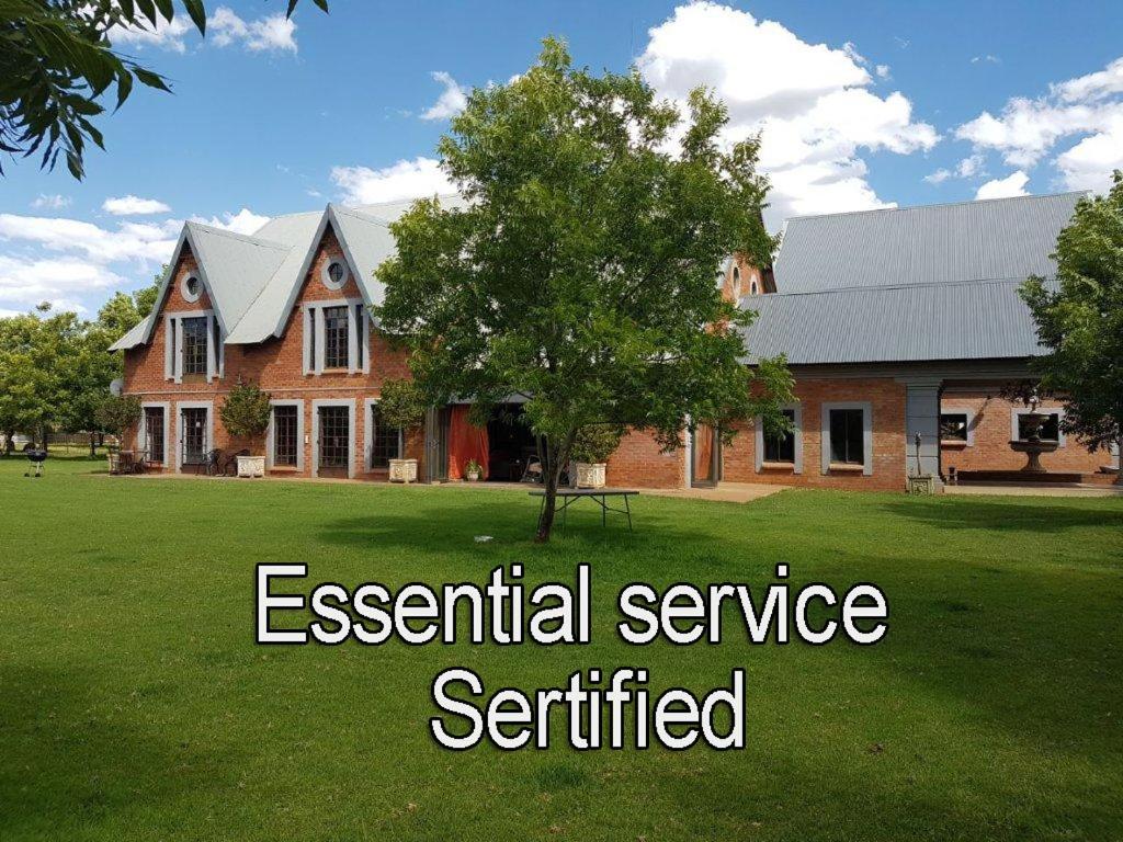 a house with the words essential service certified in front of it at Millstream Inn guest house in Skeerpoort
