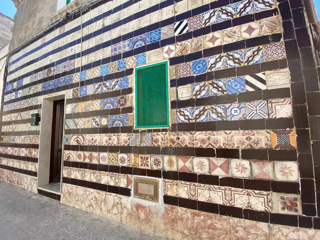 a building with mosaics on the side of it at LA CASETTA DELLE MAIOLICHE in Favignana